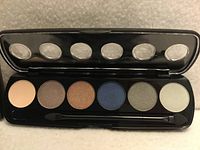 Palette open showing six eyeshadow pans, mirror and applicator