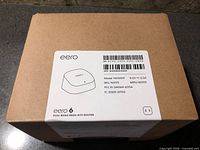 Top of sealed box showing eero 6 label with model, SKU, power specs