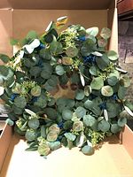 Full view of faux eucalyptus wreath inside box