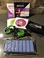 SpinGym device, DVDs, booklet, pouch, ankle weights overview