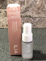 Bottle and box of Ilia Blue Light Mist 14 ml shown front view