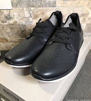 angled front view of both shoes on box