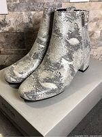 Side view of both ankle boots on box