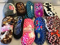 All ten pairs of assorted slippers laid out