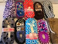 Group shot of all ten pairs of slippers showing assorted colors and patterns