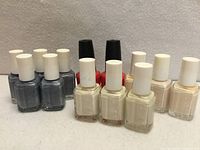 Group of 13 nail polishes showing shades and brands
