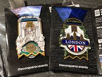 Front view of both London and Rome medals on backing cards