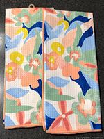 Front view of both floral waffle tea towels