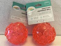Two tagged ZippyPaws ZippyTuff pink squeaker balls front view