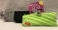 Grey felt pouch, black felt pouch and lime green Zipit Monster pencil case with tag displayed