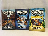 Front covers of all three Dog Man books
