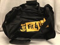 Front view of bag showing logo, handles and shoulder strap