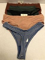 All five pairs stacked showing colors and styles