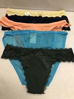 Five overlapping pairs of underwear displaying front view and color assortment