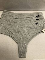 Five grey underwear laid flat showing front view