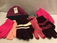 Group shot showing all three hats and five glove pairs