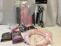 All new packaged combs, scissors, clips, scrunchies, rollers and pink curling rod displayed