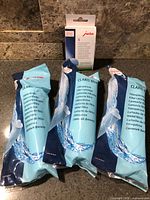 Overview showing three Claris Blue filter cartridges and one box of Jura cleaning tablets