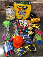 Full grouping showing markers, pencils, notebooks, erasers, toys