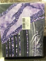 Front of sealed package showing marbled print pattern and barcode label