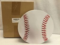 Front view of baseball-shaped wooden piggy bank beside original box