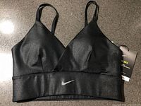 Front view of black Nike Indy sports bra with tags attached