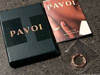 Ring in Pavoi box with booklet and plastic sleeve