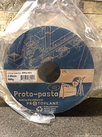 Front view of sealed Proto-pasta Silver Smoke filament spool showing branding