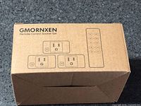 sealed box with GMORNXEN branding, illustration of three sockets and remote