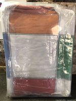 Front of sealed package showing multicolour block design comforter set