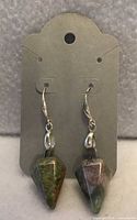 Front view showing hexagonal stone pendants and silver hooks
