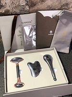 Open box showing three massage tools seated in tray