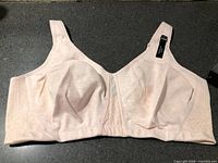 Front view of light peach wireless bra showing cups and tags attached