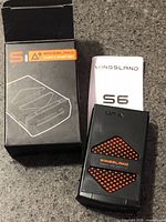 Battery, box, and instruction leaflet grouped on countertop