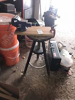 Stool with vise mounted on board and C-clamp attached