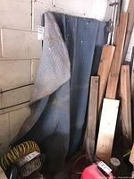 Mirrors leaning against wall covered partially by padded blanket