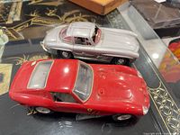 Top view of both model cars showing overall appearance, colors, scale comparison