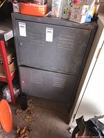 Front view of grey two-door steel cabinet with vented doors