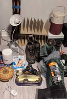 Overview showing chair in bag, boots, file sorter, lamp, thermos, Spa-FX box and misc items