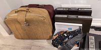 Group view of tan suitcase, burgundy suitcase, two Samsonite attachés, box of ties and cedar shoe trees