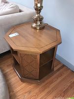 Angled view showing octagonal top, shelving, finish