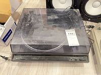 Turntable with dust cover closed showing model tag and wear
