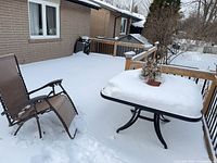 Table and one chair on snowy deck