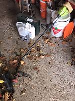Full view of string trimmer lying on floor