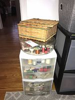 Entire lot showing Sterilite drawers, round thread caddy and wicker basket stacked