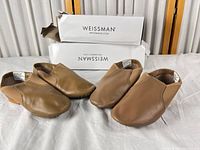 Four individual shoes showing both pairs with boxes