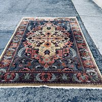 Full view of rug showing complete pattern and fringe