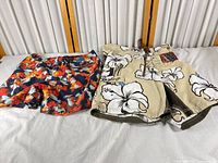 Both pairs of boardshorts side by side