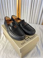 Pair of Bruno Magli black loafers on box