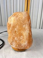 Front view of Himalayan salt lamp on wood base